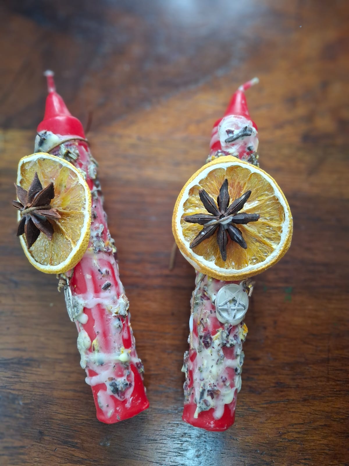 Red dressed candle with dried lemon and clove – for love, protection, and ritual energy.