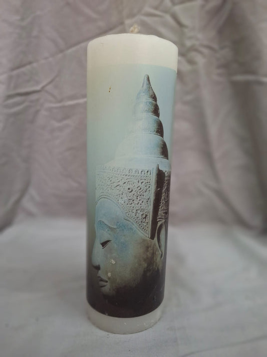 White decorative candle with blue side-view Buddha design